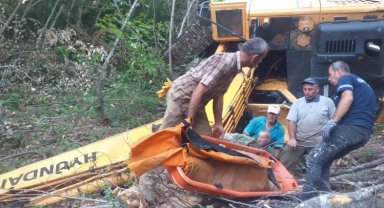İş makinesi yol açma çalışmasında dik yamaçtan uçtu, operatör altında kaldı